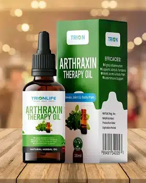 Trionlife Arthraxin Therapy Oil 30ml amber dropper bottle with white and green label, standing beside its green TRION box on a wooden table.